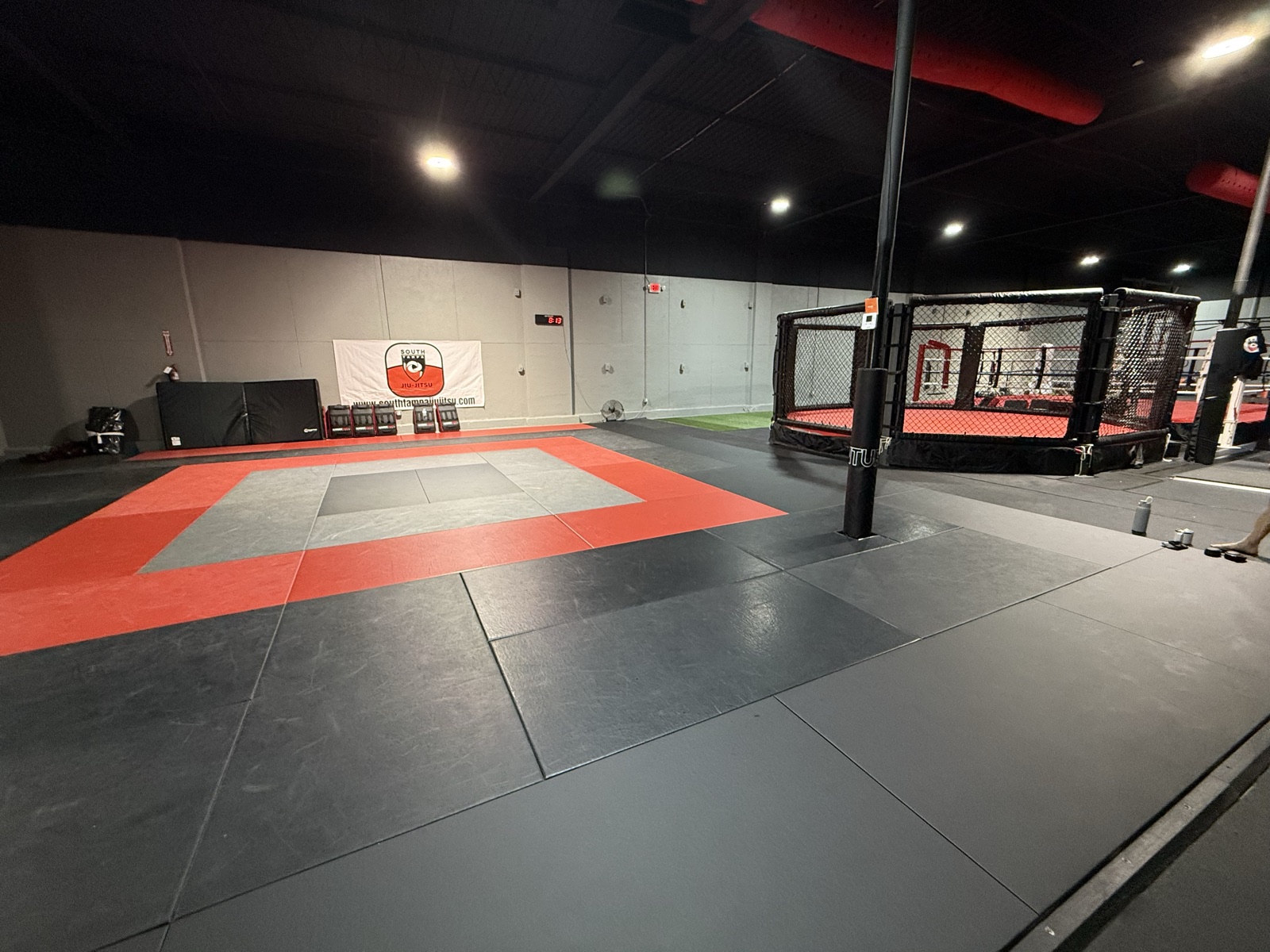 The mat room and MMA cage at South Tampa Jiu-Jitsu & MMA